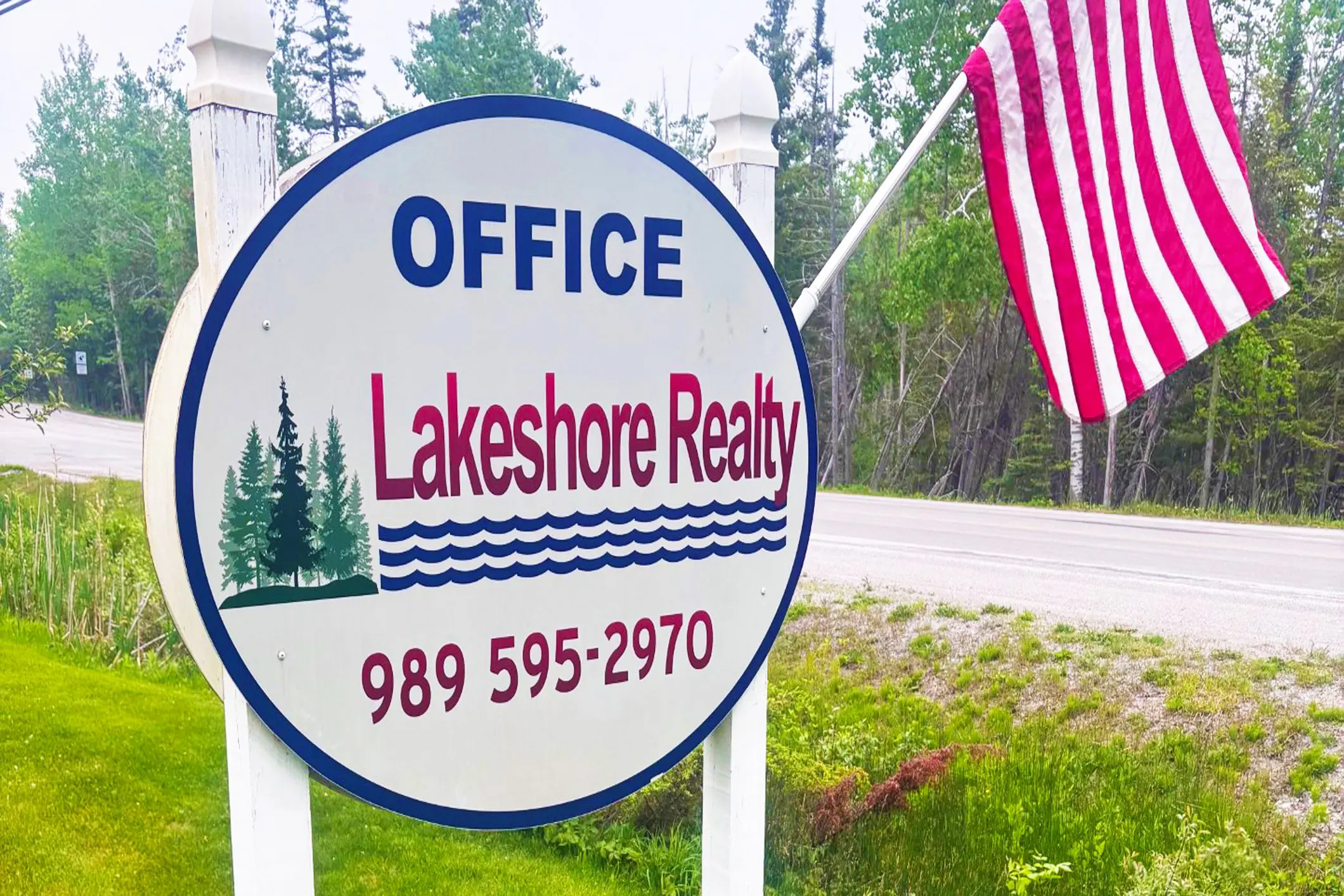 Lakeshore Realty office sign with American flag.