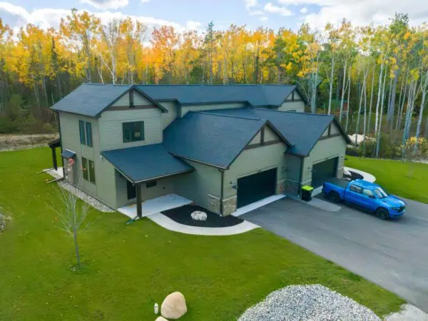 Modern house with a blue truck outside.