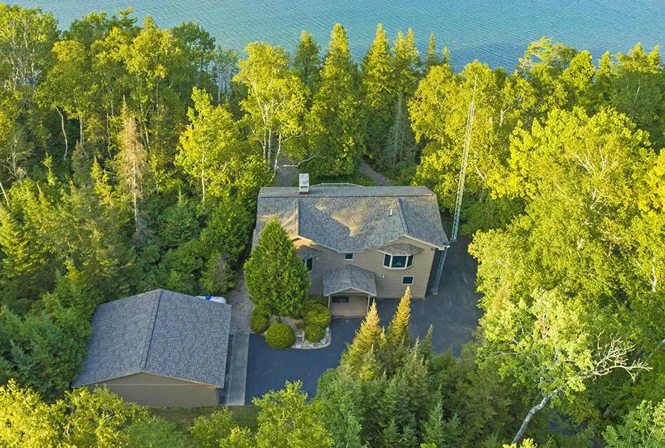 Aerial view of house by the lake.