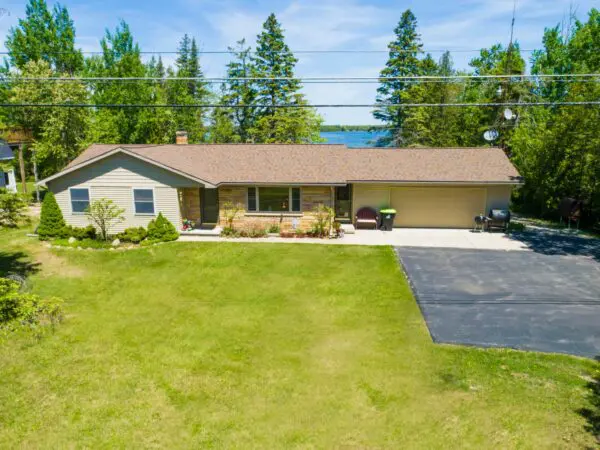 Single-story lakeside ranch with large front lawn