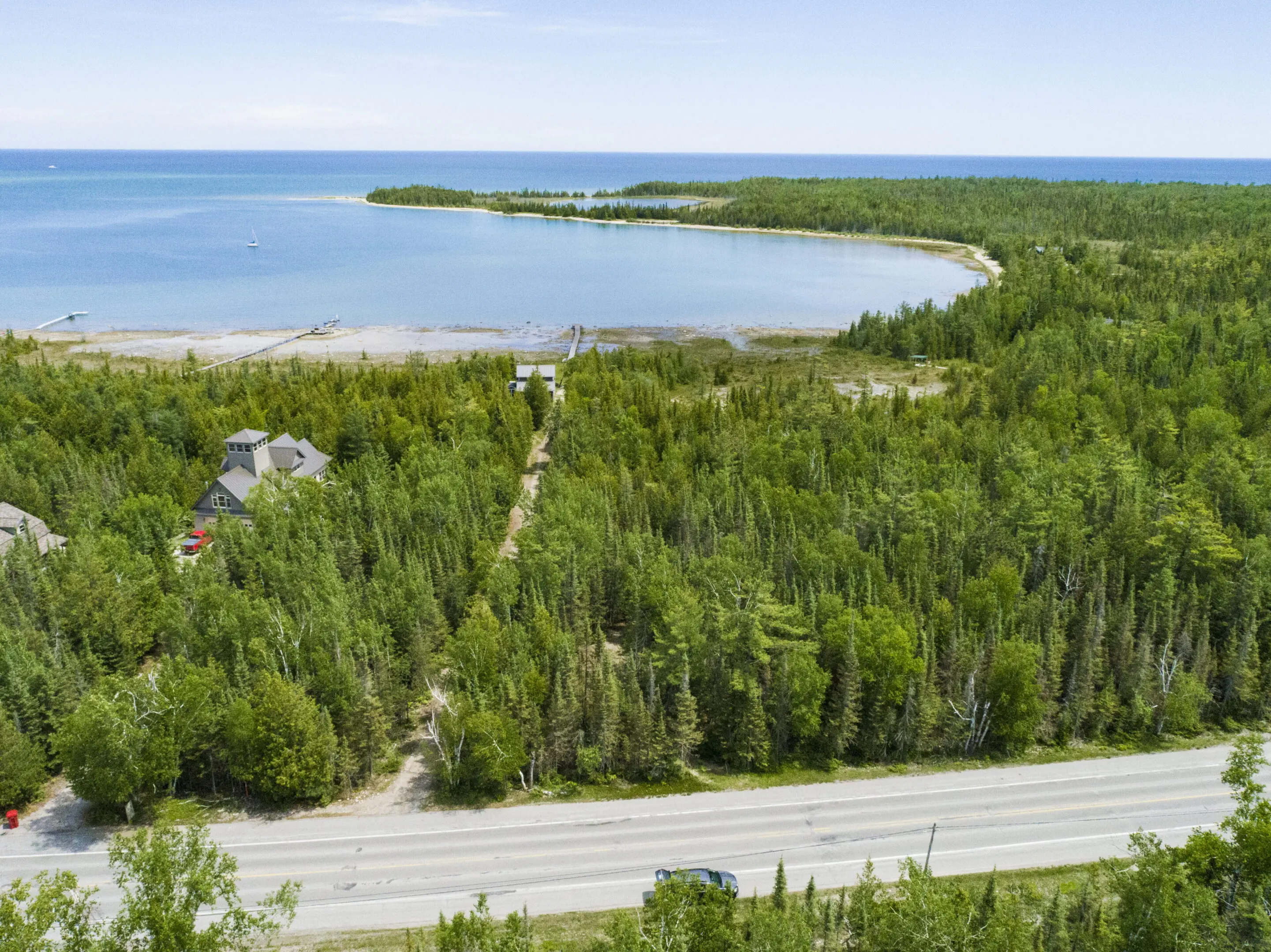 Aerial view of forested coastline and tranquil bay