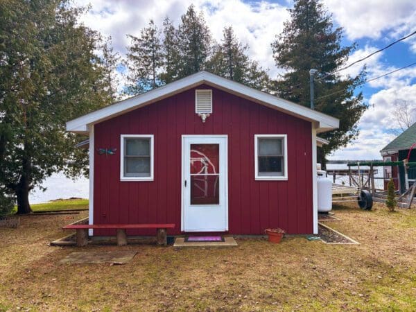 Red cabin with white door and windows.